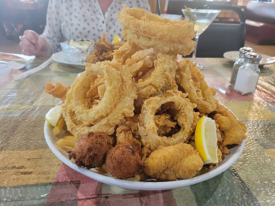 Golden fried seafood beside lemon wedges.